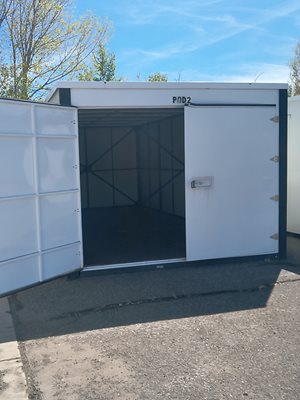 A white container with the label "POD2" is open, revealing a dark interior.